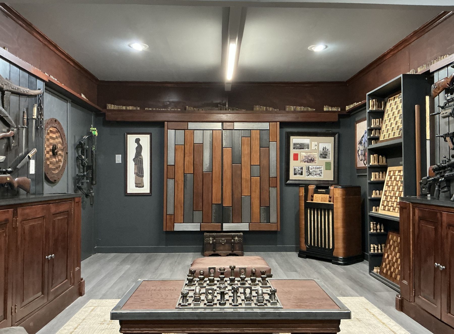 A wood and steel art panel beside a vintage console radio